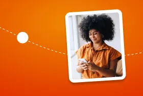 A woman with curly hair is looking at her phone